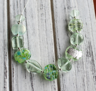 A Green Depression Glass platter was used to make the beautiful beads in this necklace.