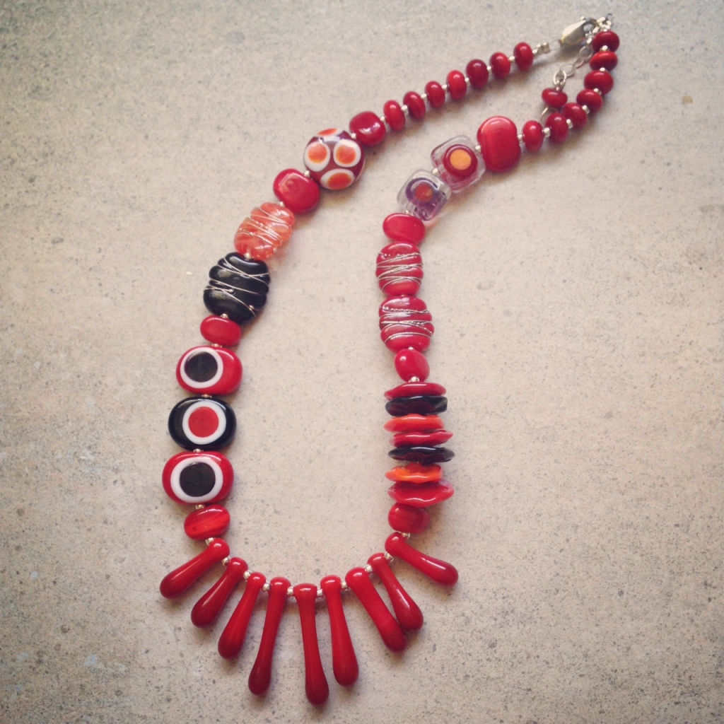 Gorgeous red necklace with a splash of orange and black!  handmade glass beads by Julie Frahm