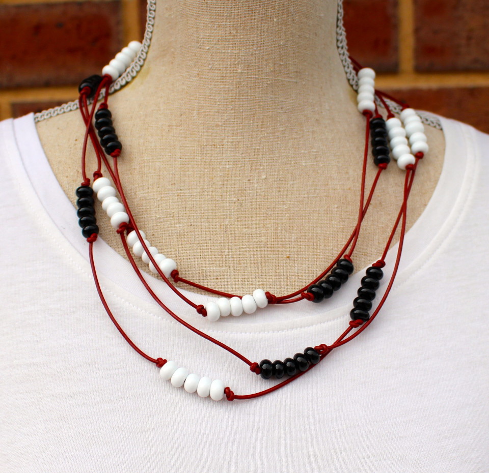 Black and white bead necklace on red leather, handmade glass beads by Julie Frahm