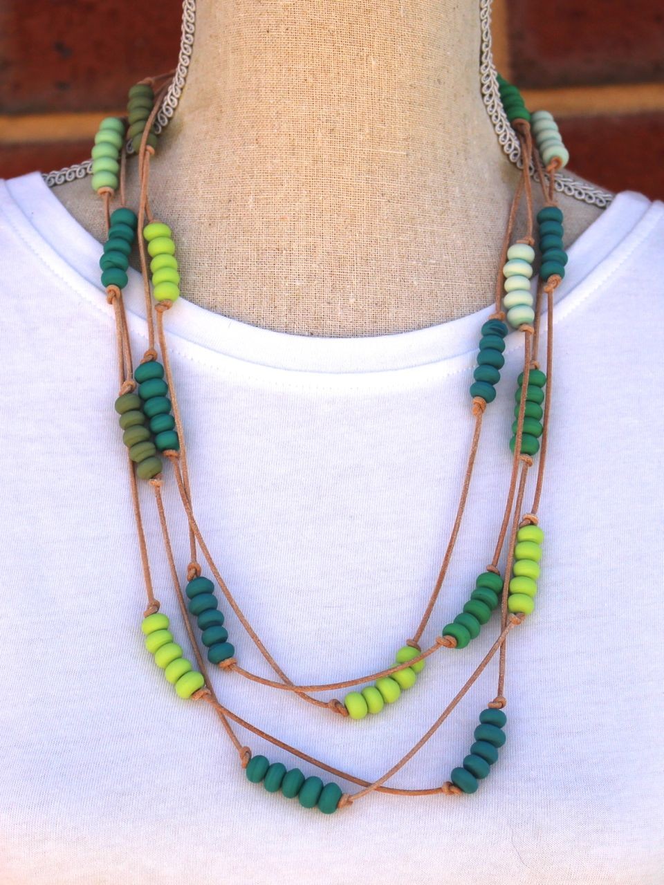 Green beads on leather wraparound necklace.