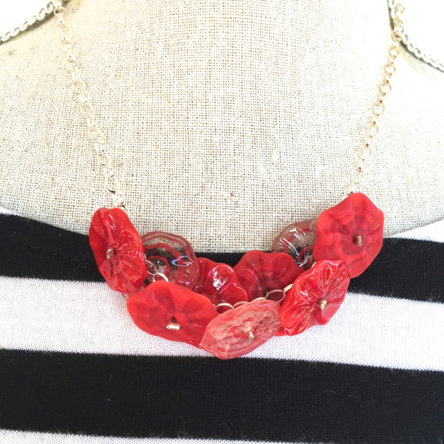 Red flower disk necklace on silver chain