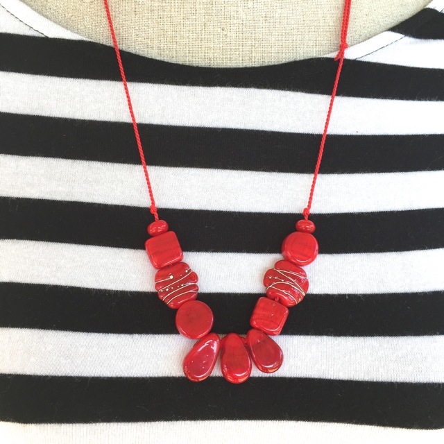 Red glass bead necklace on silk cord