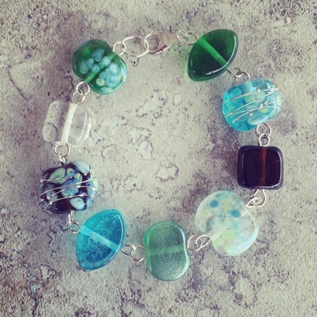 A beautiful glass bracelet, featuring beads made from gin and tonic bottles 