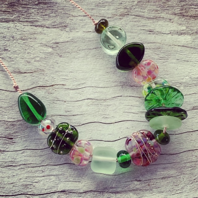 Pink and green recycled glass necklace on silk cord