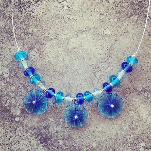 Blue glass flower necklace and matching earrings