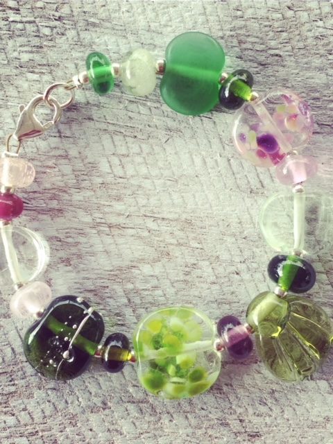 Recycled glass flower bracelet | beads made from assorted wine bottles and other broken glass objects.