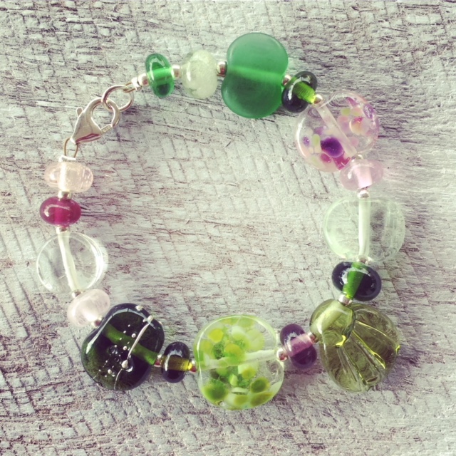 Recycled glass flower bracelet | beads made from assorted wine bottles and other broken glass objects.