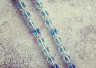 Recycled glass bead necklace, featuring beads made from wine bottles