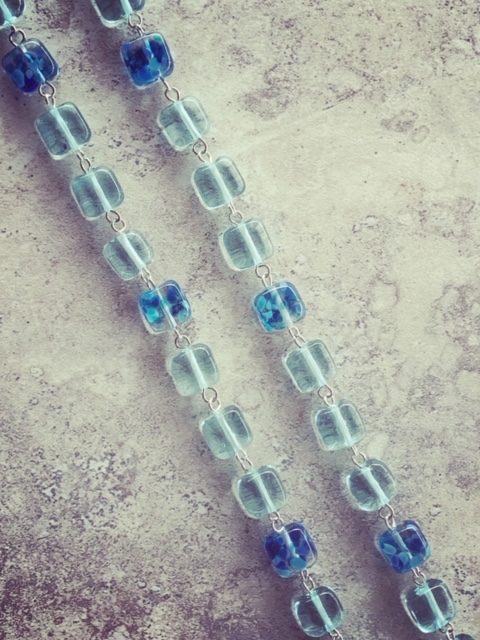 Recycled glass bead necklace, featuring beads made from wine bottles
