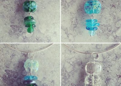 Gin and tonic pendant necklaces featuring beads made from Tanqueray and Bombay Sapphire Gin, plus Fever-Tree tonic water bottles