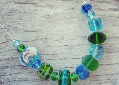 Gin and tonic necklace featuring beads made from Bombay Sapphire and Tanqueray Gin bottles