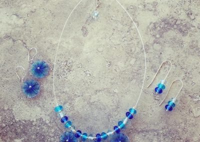 Blue glass flower necklace and matching earrings