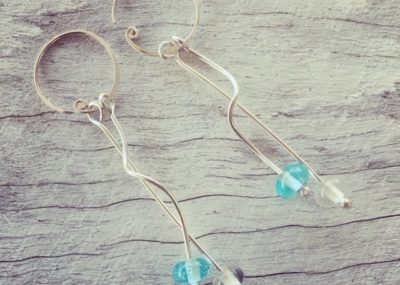 Long, curly Bombay Sapphire Gin earrings