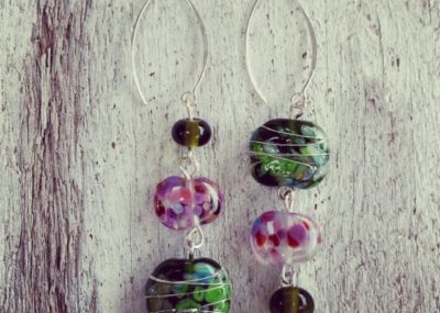 Day 71. Just out of curiosity, do you prefer the way the earring on the left goes from smallest to largest bead? Or do you prefer the earring on the right that goes from largest to smallest bead? I must confess, my plan for the earrings was the earring on the left, but when I tried it the other way, I preferred the one on the right! It’s one of the reasons I love this challenge, because it’s gets designs out of my head and into reality, where things can sometimes end up different from what I had planned. These earrings feature a variety of recycled glass beads made from wine and champagne bottles.