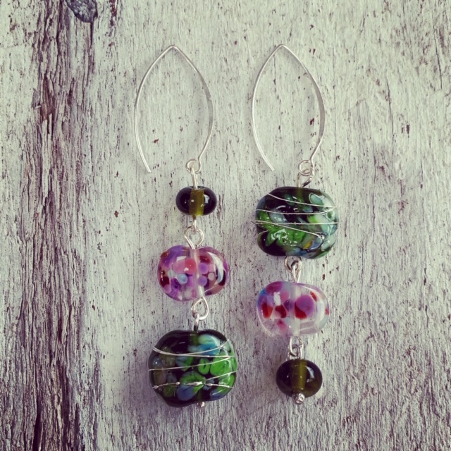 Day 71. Just out of curiosity, do you prefer the way the earring on the left goes from smallest to largest bead? Or do you prefer the earring on the right that goes from largest to smallest bead? I must confess, my plan for the earrings was the earring on the left, but when I tried it the other way, I preferred the one on the right! It’s one of the reasons I love this challenge, because it’s gets designs out of my head and into reality, where things can sometimes end up different from what I had planned. These earrings feature a variety of recycled glass beads made from wine and champagne bottles.