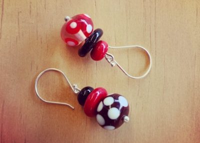 Red, black and white mismatched earrings