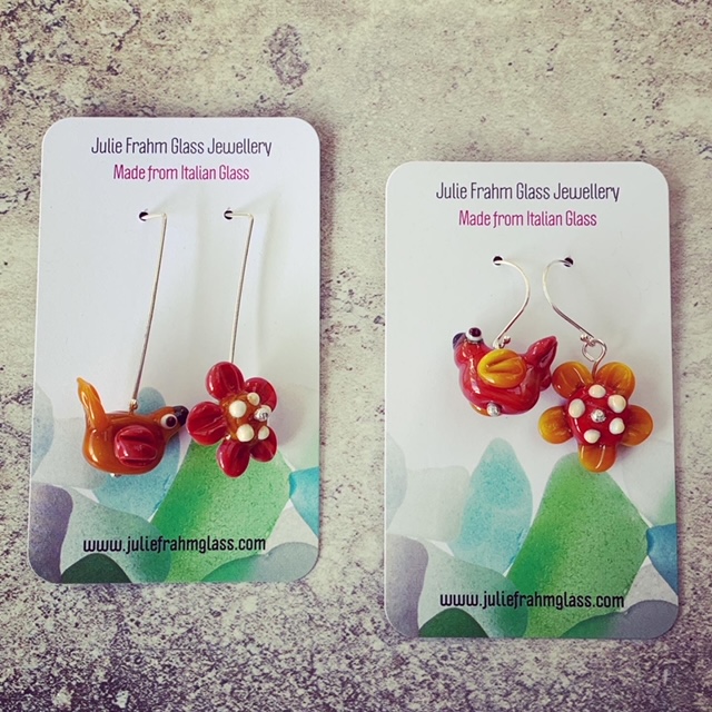 mismatched bird and flower earrings